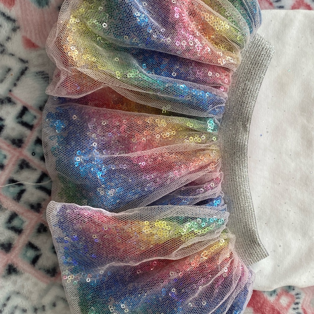 A 12 month old birthday outfit rainbow sequin skirt and head band bow